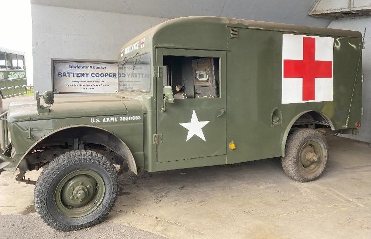 A military vehicle with a white star and a red cross on the side

Description automatically generated